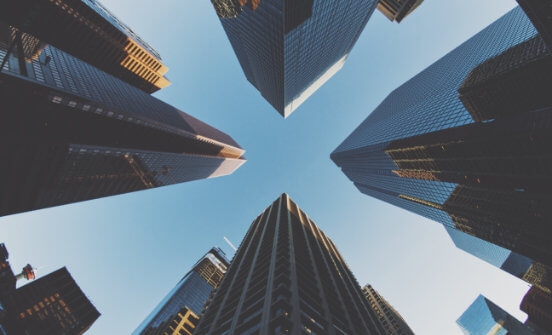 A skyward shot of four intersecting skycrapers.